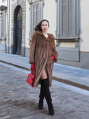 Vintage pastel Canadian brown mink fur coat styled with thigh-high boots and red gloves, offering a bold and elegant winter fashion look.