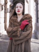 Model wearing vintage pastel Canadian brown mink fur coat with red gloves, showcasing plush collar and premium mink fur detail.
