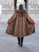 Back view of vintage pastel Canadian brown mink fur coat flared open, showcasing full fur volume and elegant craftsmanship.