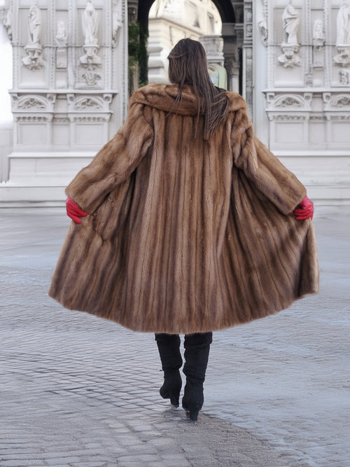 Back view of vintage pastel Canadian brown mink fur coat flared open, showcasing full fur volume and elegant craftsmanship.