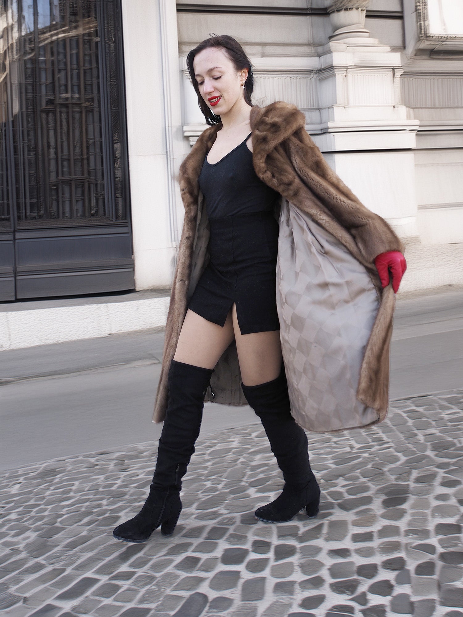 Vintage pastel Canadian brown mink fur coat open to reveal satin lining, styled with black dress and boots for modern winter elegance.