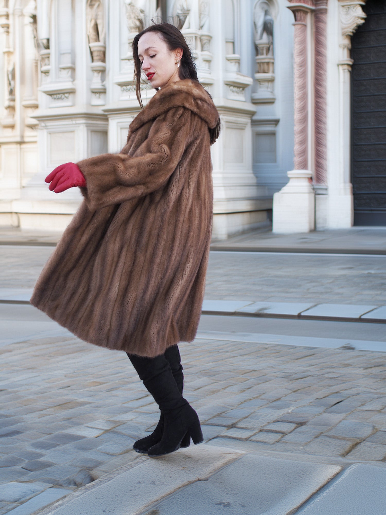 Side view of vintage pastel Canadian brown mink fur coat with red gloves, styled for classic winter fashion and luxury appeal.