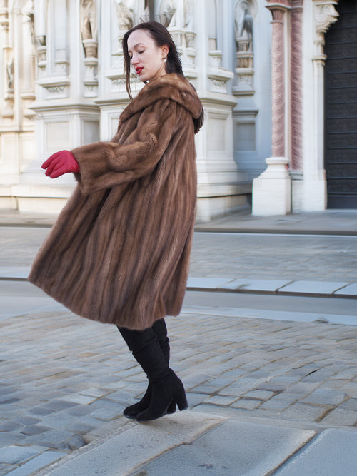 Side view of vintage pastel Canadian brown mink fur coat with red gloves, styled for classic winter fashion and luxury appeal.