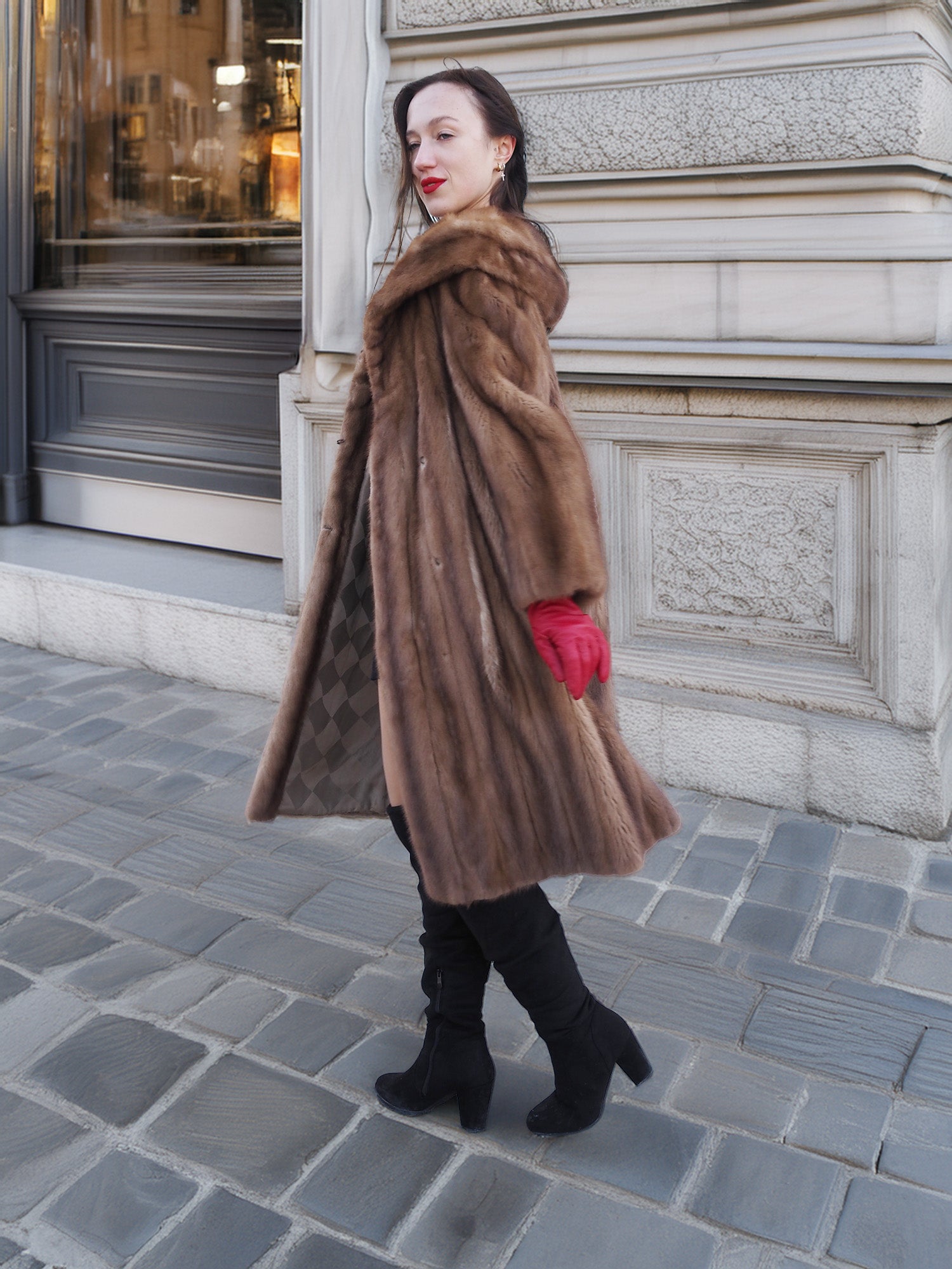 Model walking in vintage pastel Canadian brown mink fur coat with red gloves, showcasing elegant outerwear for cold-weather sophistication.