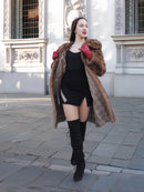 Model in motion wearing vintage pastel Canadian brown mink fur coat over black dress, ideal for bold and elegant winter fashion.