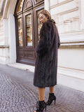 Woman in dark fur coat, stylish city backdrop