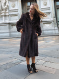 Woman in dark fur coat, elegant city architecture