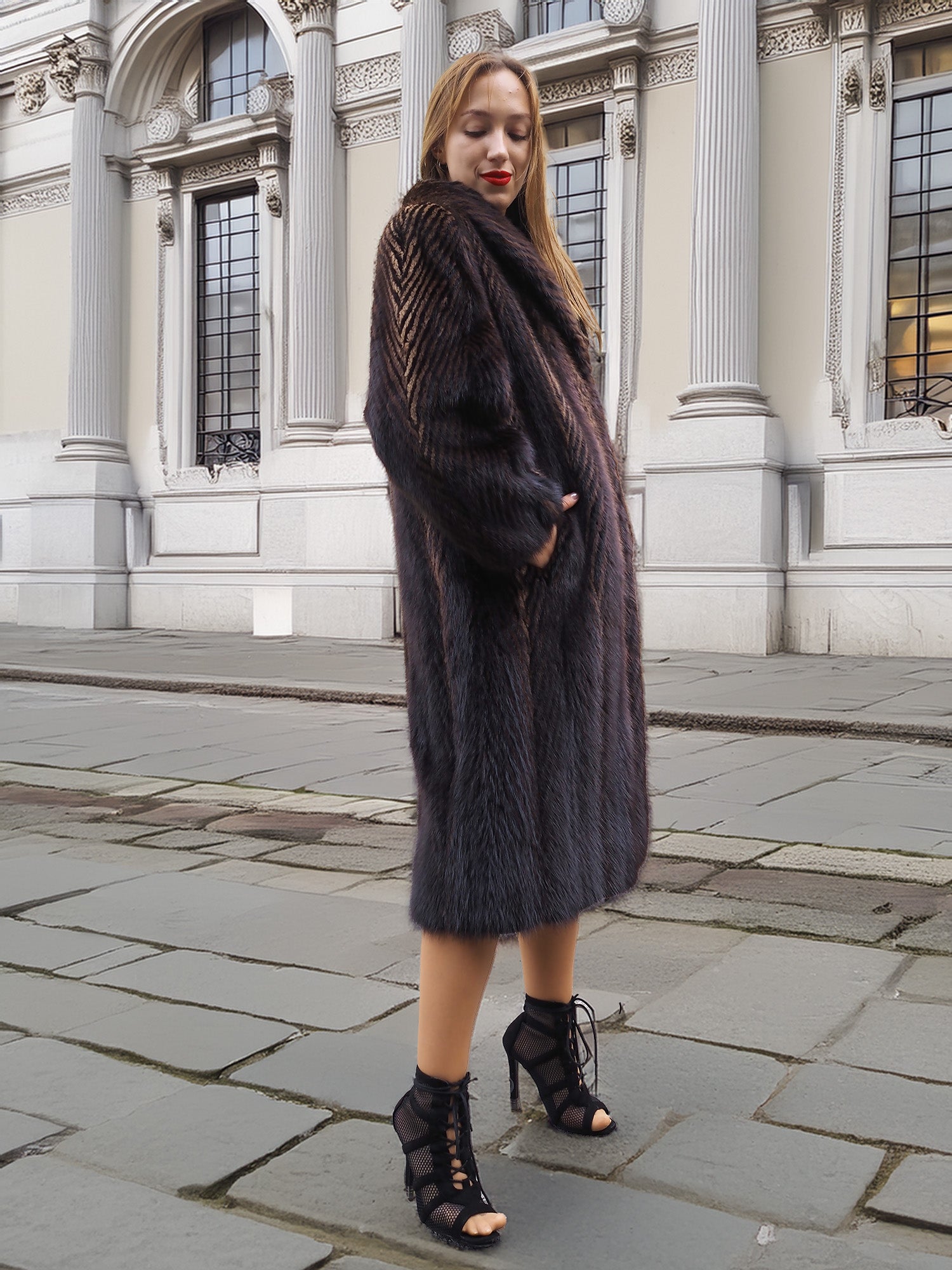 Woman in dark fur coat, posing on city street