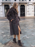 Woman in dark fur coat, posing with confidence