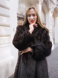 Woman in dark fur coat, posing with confidence