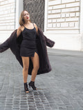 Woman in dark fur coat, revealing stylish outfit