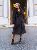 Smiling woman in dark fur coat, elegant architecture