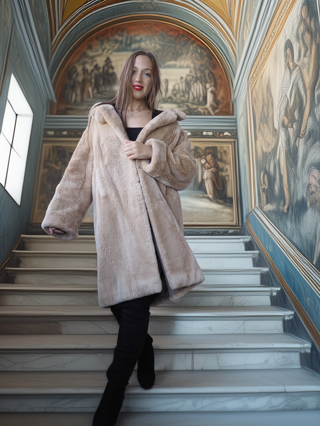 Woman in a fur coat standing on a staircase with classical frescoes in the background