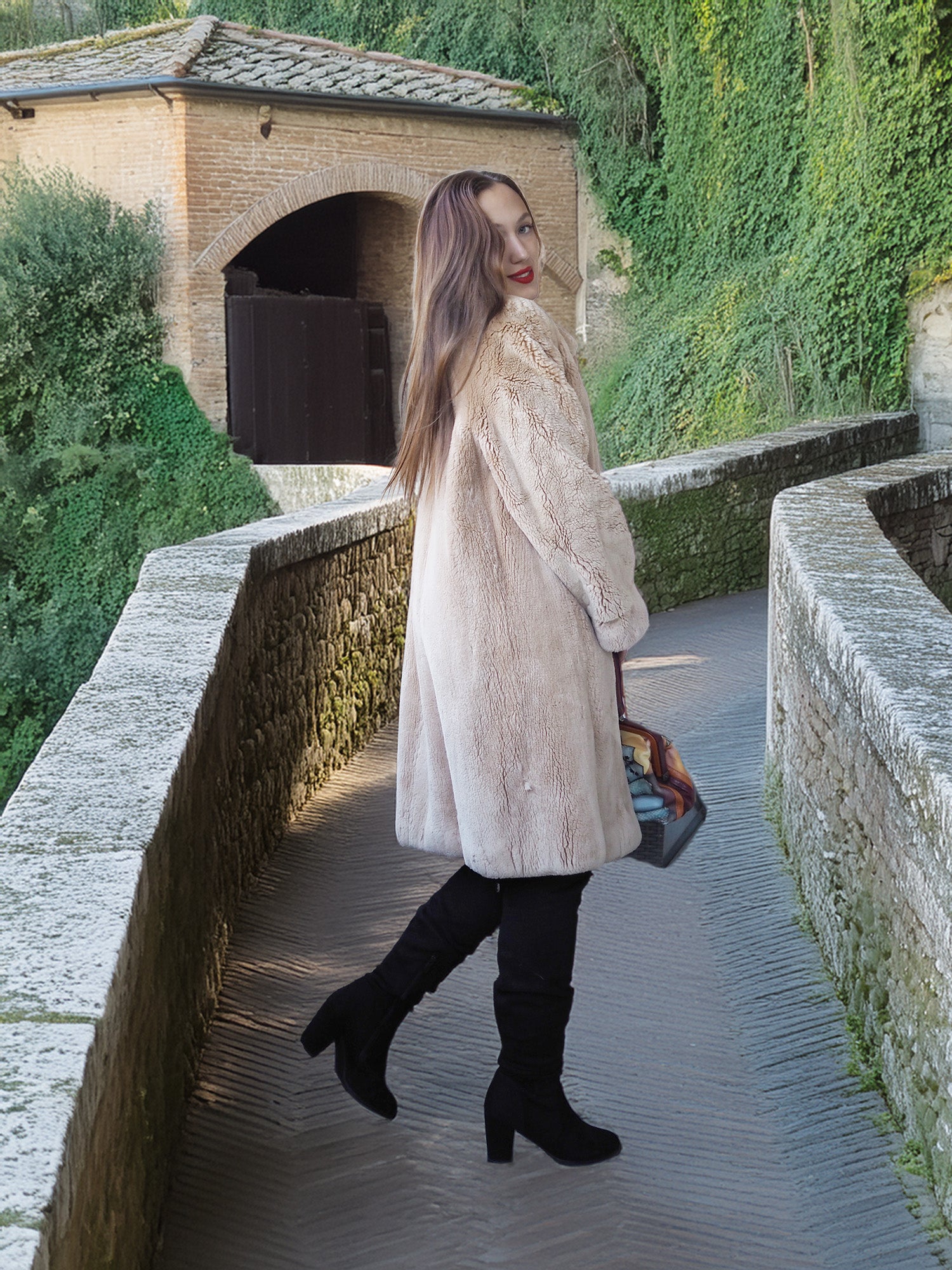 Woman in a fur coat walking on a stone path with greenery