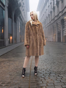 Full front view of classic pastel brown mink fur coat stroller jacket M/L in cityscape. Pre-owned mink coat with notch collar and cuffs.