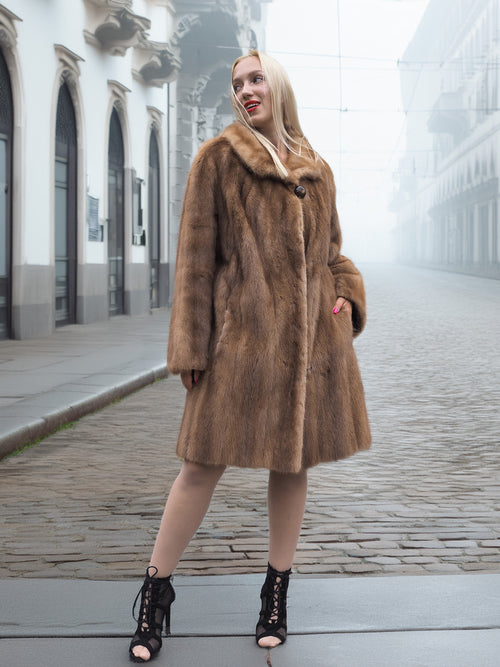Model poses in classic pastel brown mink fur coat stroller jacket M/L with button closure. Natural brown mink coat for elegant looks.