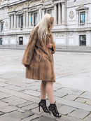 Classic pastel brown mink fur coat stroller jacket M/L styled with heels in front of ornate building. Pre-owned luxury fur outerwear.