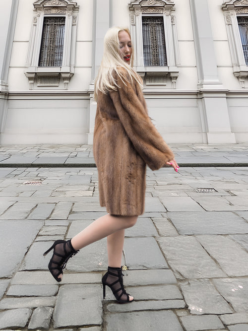 Side profile of classic pastel brown mink fur coat stroller jacket M/L in motion. Natural brown mink fur with soft, supple texture.