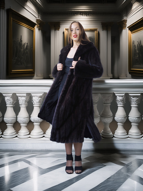 Woman in a dark coat standing in an elegant interior setting with classical architecture.