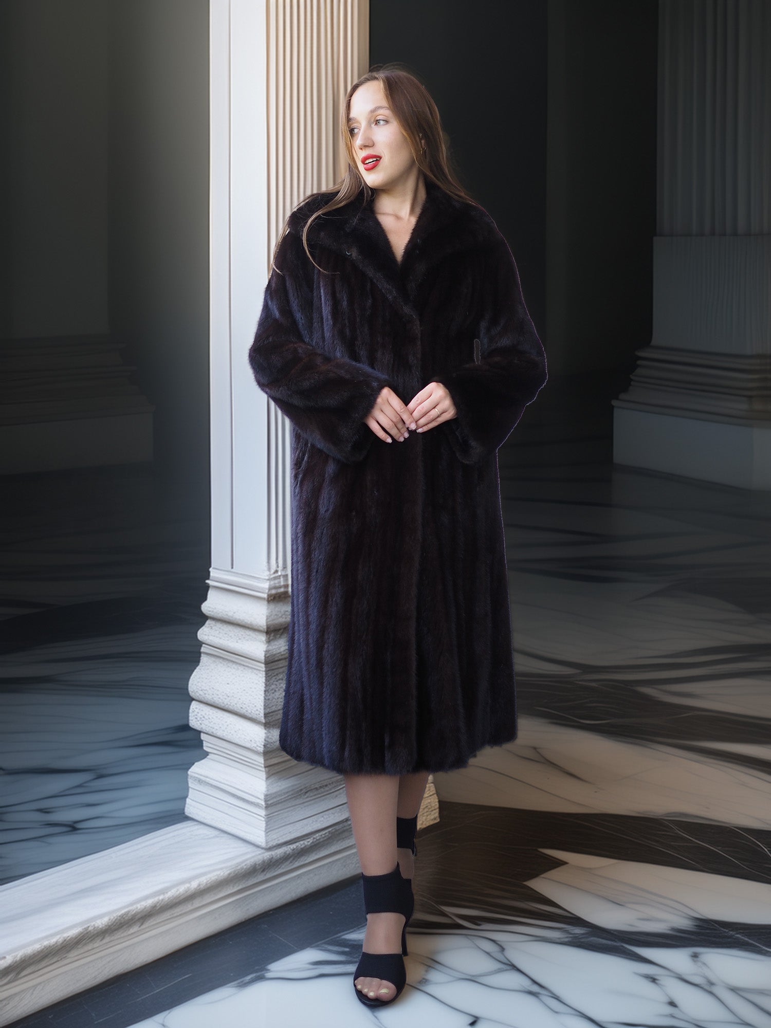 Woman wearing a dark fur coat standing in an elegant interior setting.