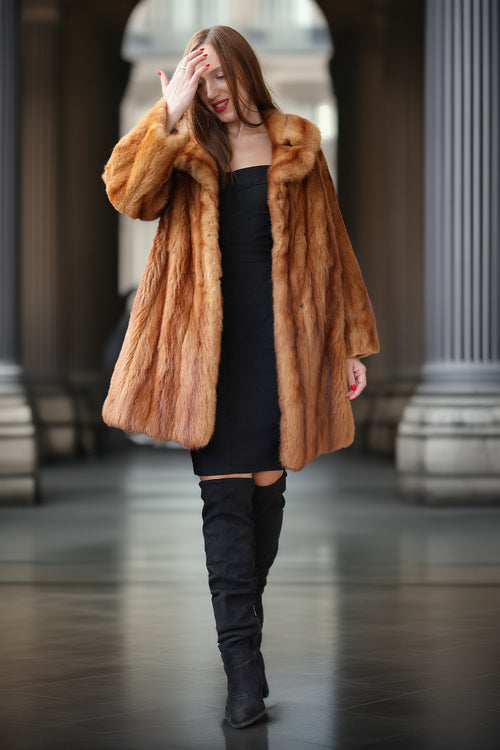 Vintage mink fur coat with hood in orange-brown; draped shoulders over black dress