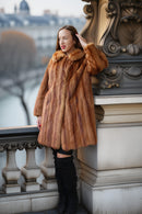 Vintage mink fur coat with hood, orange-brown; three-quarter view with soft collar