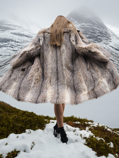 Back view of flowing vintage fur coat in snow