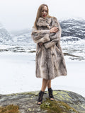 Model in fur coat with shawl collar in snowy scene