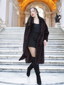 La Galleria mahogany mink fur coat styled on marble stairs, showcasing its full-length cut and luxurious texture for winter elegance.