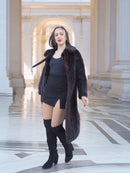Model walking in La Galleria full-length mink fur coat, revealing satin lining and rich mahogany color for luxury winter fashion.