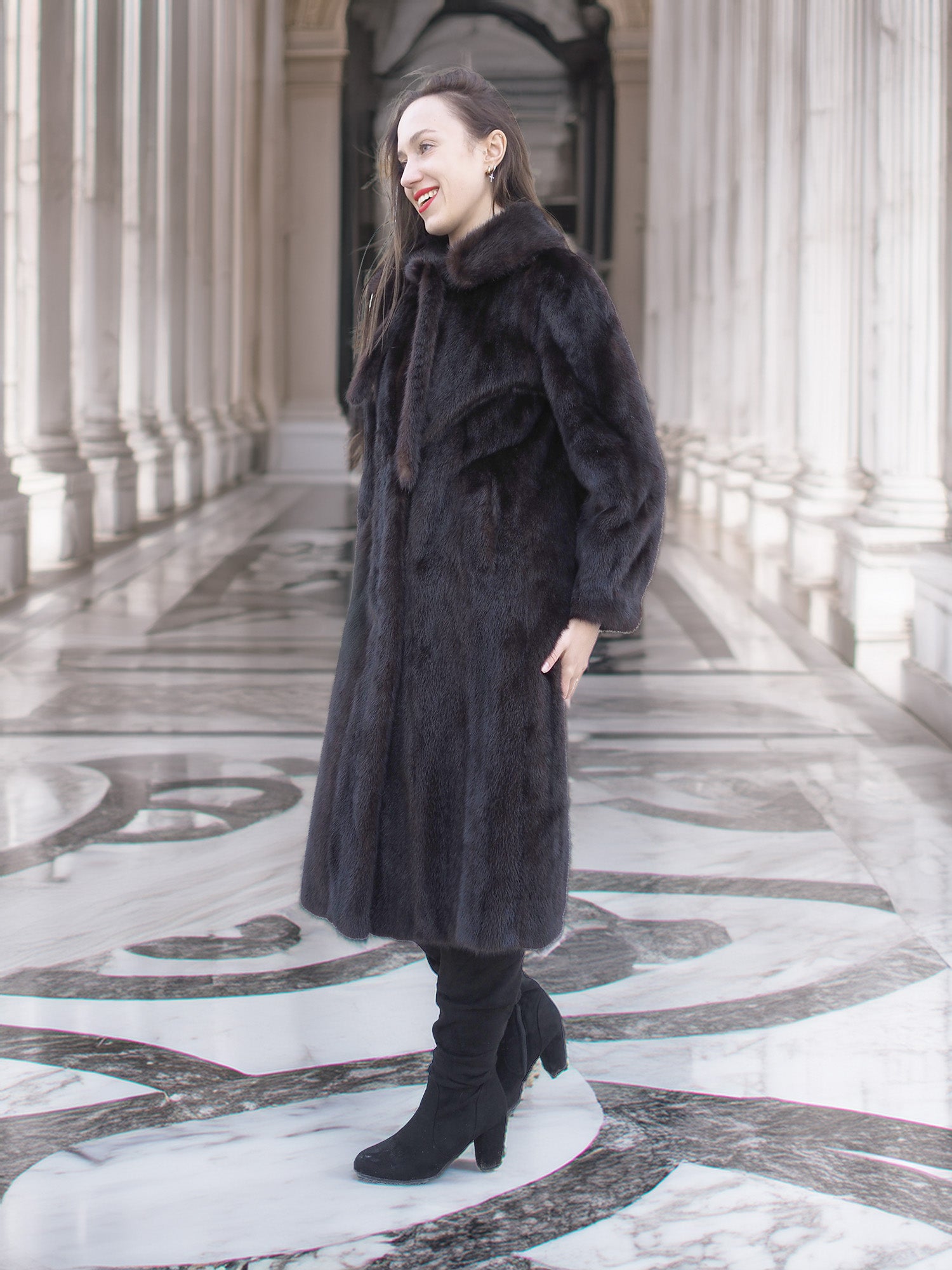 Side view of La Galleria vintage mink fur coat in mahogany, styled with black boots for a luxurious cold-weather outerwear look.