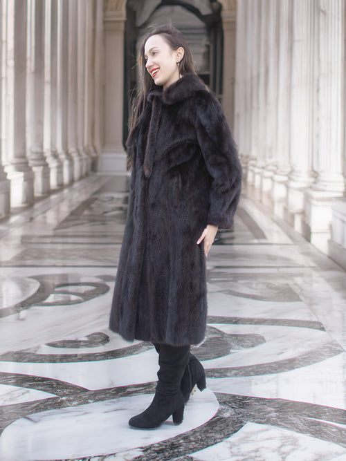Side view of La Galleria vintage mink fur coat in mahogany, styled with black boots for a luxurious cold-weather outerwear look.