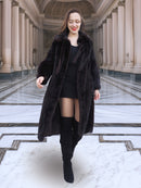 Model walking in La Galleria vintage mink fur coat with tie closure, showcasing its full-length silhouette and rich mahogany color.