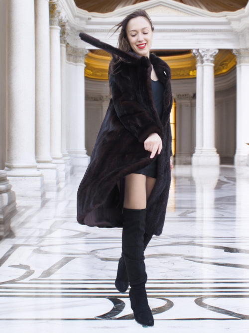 Flowing La Galleria mahogany mink fur coat with satin lining, styled with black mini dress and boots for chic winter fashion.