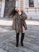 Model posing in Brand New Mink Fur Jacket L/XL 16, with soft herring bone pattern and elegant winter styling.