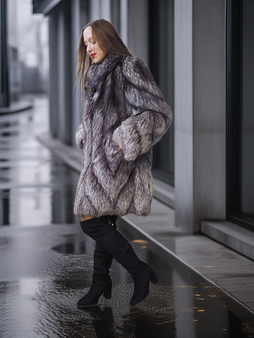 Woman wearing a fur coat walking on a wet pavement.