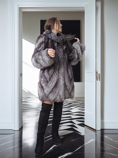 Person wearing a fur coat in a modern interior setting