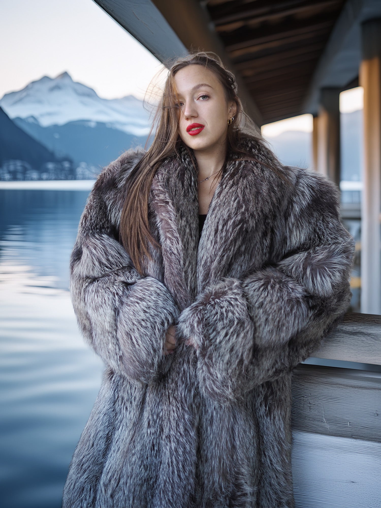 Woman wearing a fur coat with a mountainous landscape in the background
