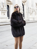 Unisex Dark Mahogany Mink Fur Bomber Jacket Coat M/L styled in front of historic architecture, showcasing its elegant, voluminous design.