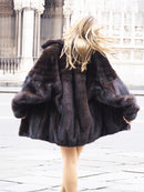 Back view of Unisex Dark Mahogany Mink Fur Bomber Jacket Coat M/L highlighting glossy mink pelts and voluminous silhouette in motion.