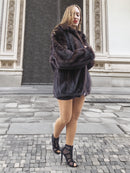Model walks in front of ornate doors wearing Unisex Dark Mahogany Mink Fur Bomber Jacket Coat M/L, showcasing its oversized luxury fit.