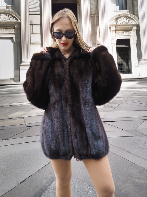 Model poses confidently in Unisex Dark Mahogany Mink Fur Bomber Jacket Coat M/L, highlighting the coat’s dark mahogany hue and soft finish.
