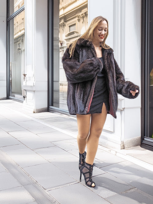 Unisex Dark Mahogany Mink Fur Bomber Jacket Coat M/L worn open, revealing inner lining and paired with a black mini dress.