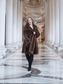 Model walking through columned hall in Brand New Luxurious Demi Buff Swing Canadian Mink Fur Coat L/XL, styled for winter elegance.