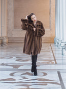 Model posing in Brand New Luxurious Demi Buff Swing Canadian Mink Fur Coat L/XL, styled with black boots in a marble corridor.