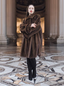 Brand New Luxurious Demi Buff Swing Canadian Mink Fur Coat Stroller L/XL with large wing collar, modeled in a marble-columned hall.