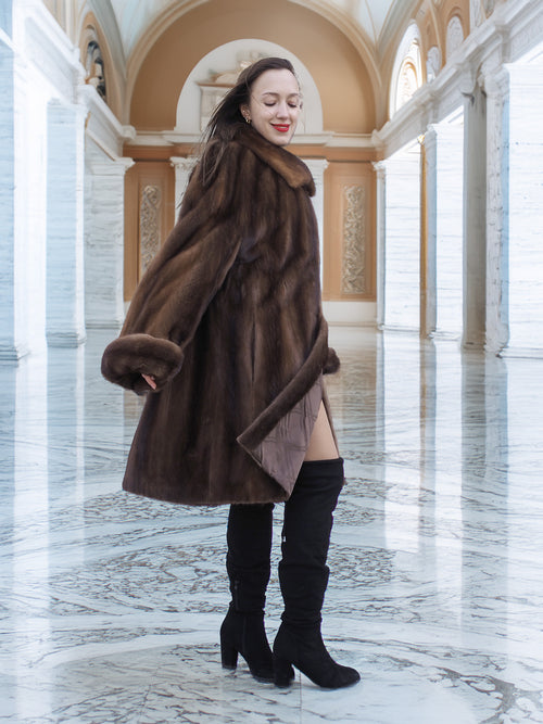 Model turning in Brand New Luxurious Demi Buff Swing Canadian Mink Fur Coat L/XL, showcasing its rich demi buff color and satin lining.