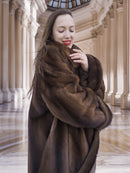 Close-up of model embracing Brand New Luxurious Demi Buff Swing Canadian Mink Fur Coat L/XL, showing soft mink fur and cozy fit.
