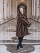 Model spinning in Brand New Luxurious Demi Buff Swing Canadian Mink Fur Coat L/XL, emphasizing the coat’s volume and luxurious texture.