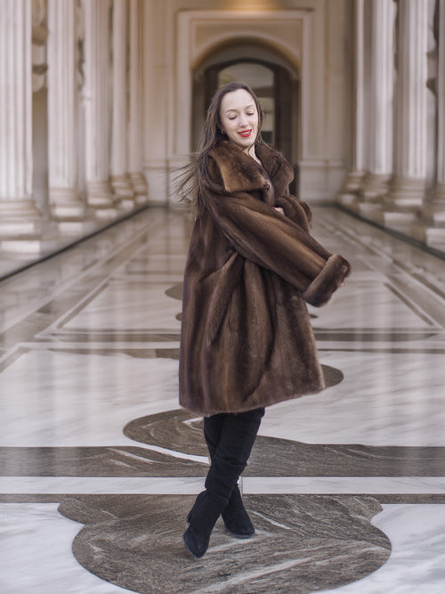 Model spinning in Brand New Luxurious Demi Buff Swing Canadian Mink Fur Coat L/XL, emphasizing the coat’s volume and luxurious texture.